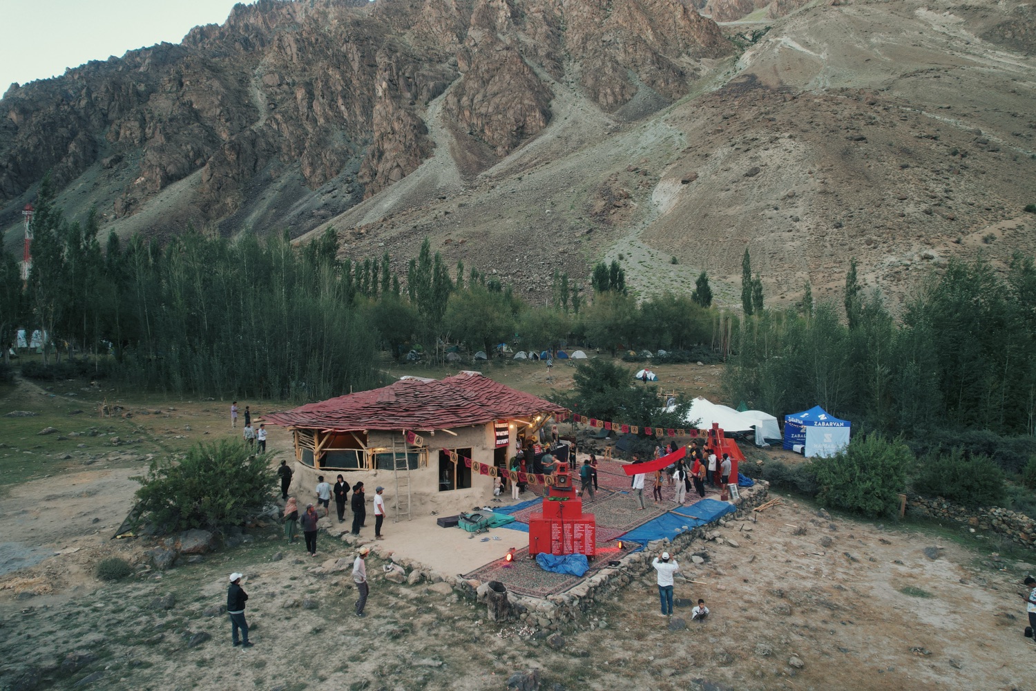 The BFR Sound System set up outdoors, the red speaker stack strung with bunting